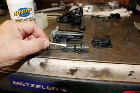 A hand holding the new pump assembly